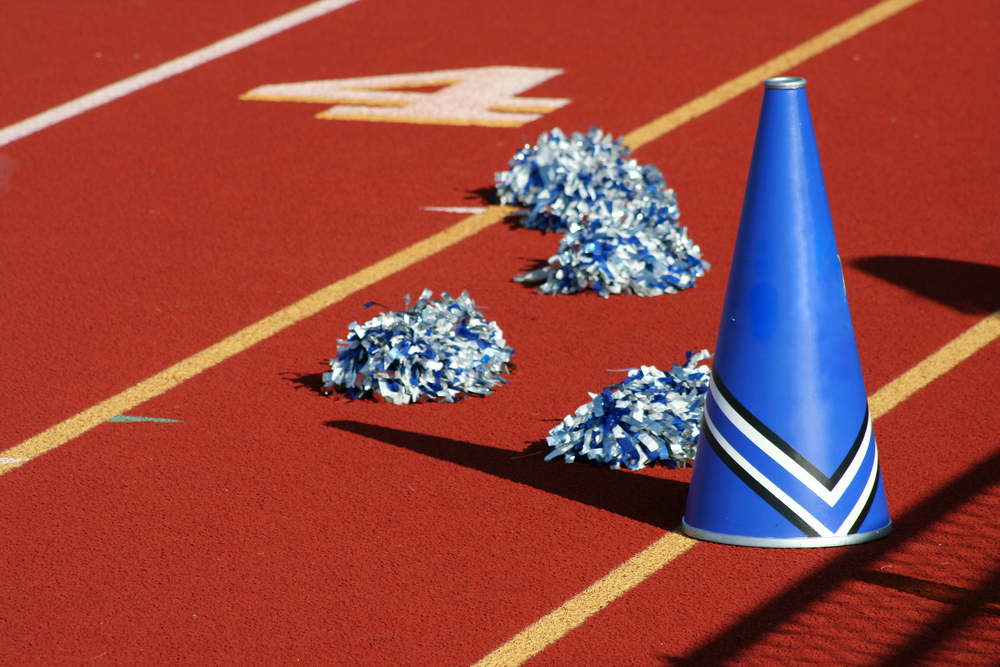 Cheerleader pom poms and megaphone